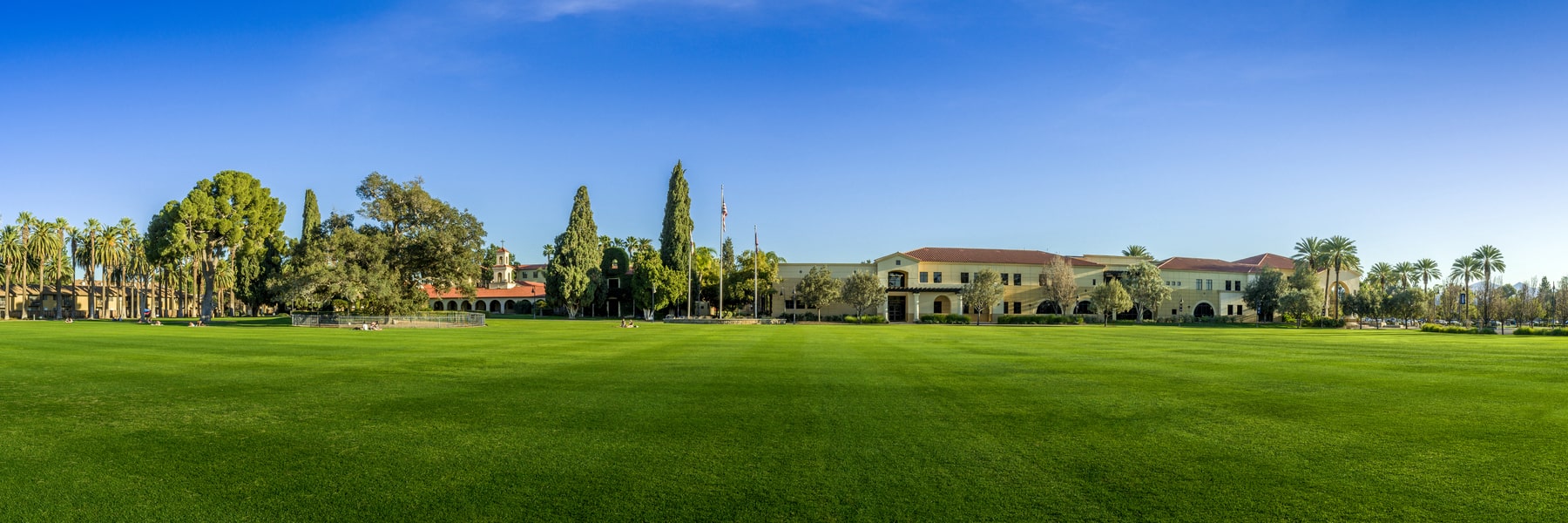 Front lawn of California Baptist University with campus buildings in the background